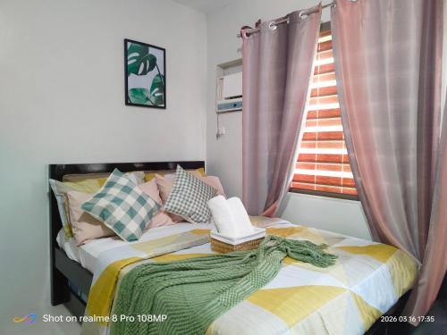 a bedroom with a bed with a hat on it at Sugarland Urban Nook in Bacolod