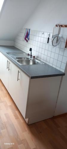 a kitchen with a sink and a counter top at Schneiderhof in Steinbach