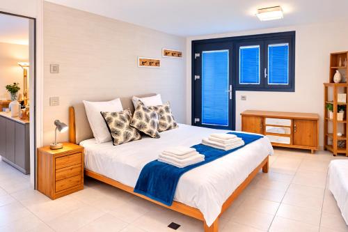 a bedroom with a king sized bed with blue shutters at Maison D'Hortense chalet le Chamois in Hérémence
