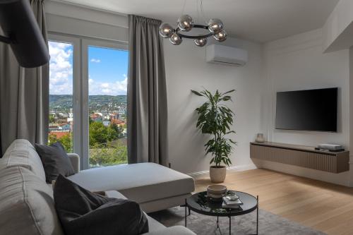 a living room with a couch and a large window at Iman Apartments in Zagreb