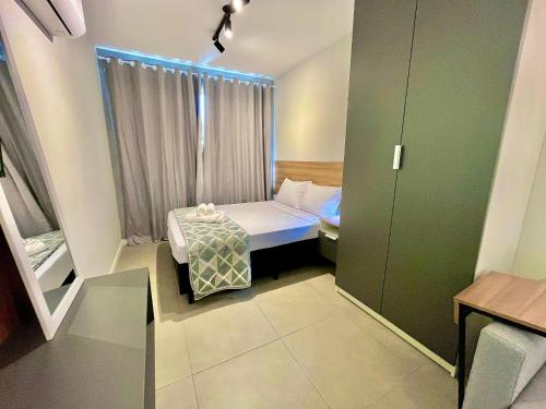 a small room with a bed and a window at Loft near Santa Casa - Apt 604 in Porto Alegre
