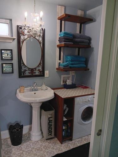 a bathroom with a sink and a washing machine at Nita's Nest in Foley