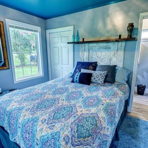 a bedroom with a bed with a colorful comforter at Nita's Nest in Foley