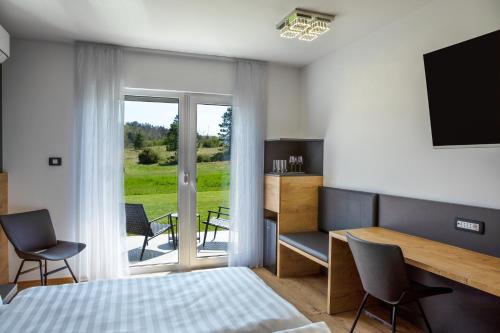 a bedroom with a bed and a table and chairs at Rooms Gašper 1 in Postojna