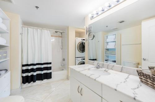 a white bathroom with a sink and a shower at 1Bd Apt with Free Parking and Amazing View in Miami