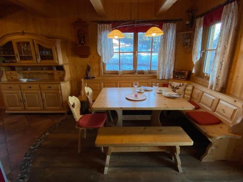 a dining room with a wooden table and chairs at Pichelhütte in Murau