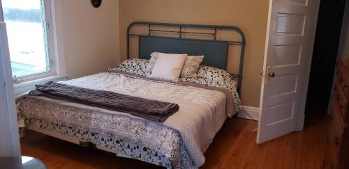a bedroom with a bed and a window at Waterfront the Alcove in Duluth