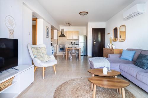 a living room with a couch and a table at Relaxing 2BDR Retreat in Protaras in Paralimni