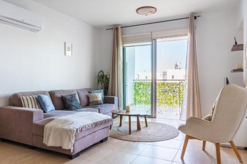 a living room with a couch and a table at Relaxing 2BDR Retreat in Protaras in Paralimni