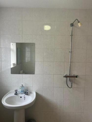a white bathroom with a sink and a shower at Hylands Hotel Family Suite with Double & Twin Rooms Ideal for Families with Children & Free Parking in Nottingham