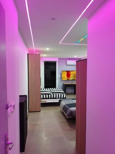 a room with two beds and purple lighting at l'Oracle Albinos in Nîmes