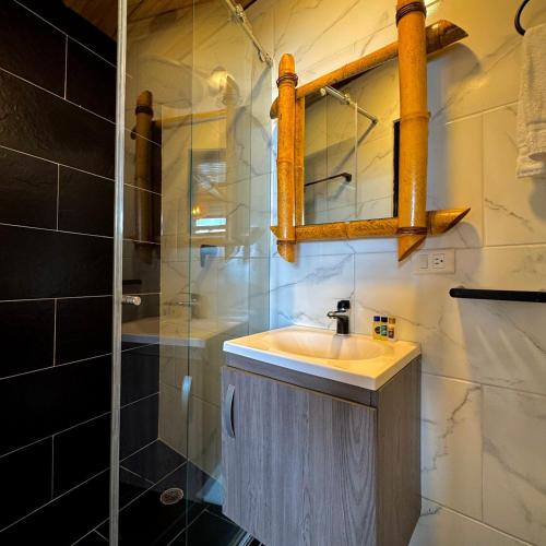 a bathroom with a sink and a shower at Hotel campestre los gabrieles in Rivera