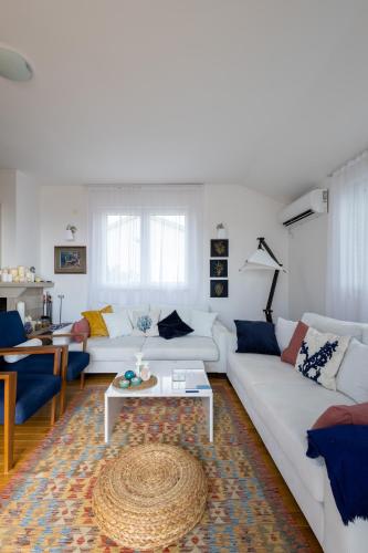 a living room with a white couch and a table at Villa Branko 12km from Dubrovnik in Ravno
