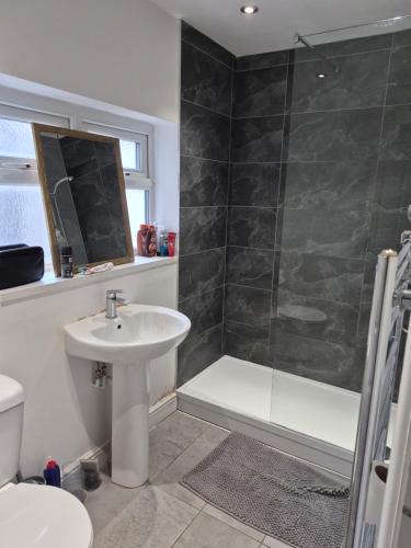 a bathroom with a sink and a shower at Double rooms in Crosby