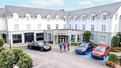 a group of people standing in front of a hotel at Killarney Riverside Hotel in Killarney