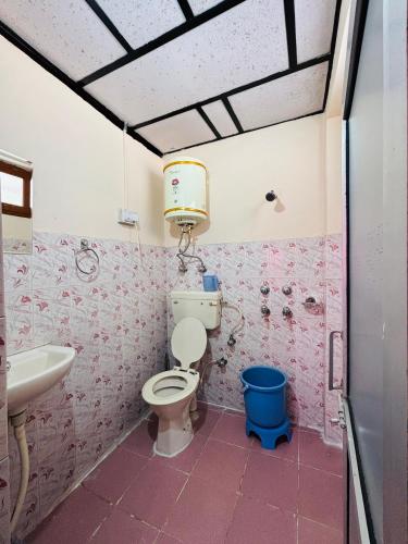 a bathroom with a toilet and a sink at Abhi house Naddi in McLeod Ganj
