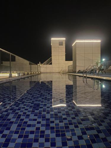a swimming pool at night with a building at Luxeliving Homes in Nairobi