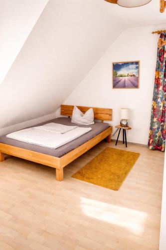 a bedroom with a bed in a attic at Hotel zum Rednitzgrund in Stein
