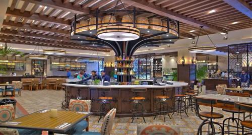 a bar in a restaurant with tables and chairs at Pueblo Bonito Sunset Beach Owners Exec Suite 1BR2B REQUEST DATE see Clay & Lisa in Cabo San Lucas