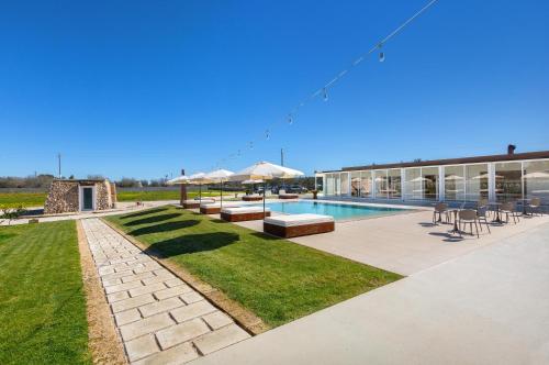 a large building with a swimming pool and grass at Agriturismo Agricola Chiani in Melendugno