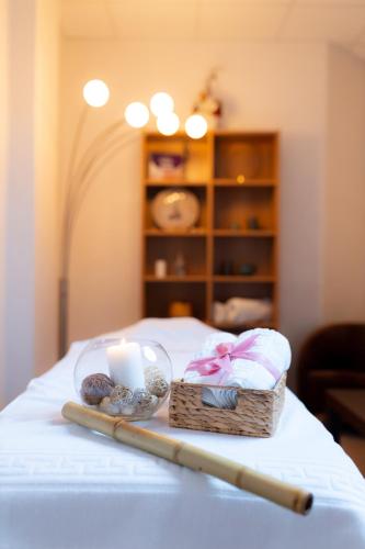 a table with a basket and a candle and a baseball bat at Hotel Terra Balneo in Galaţi