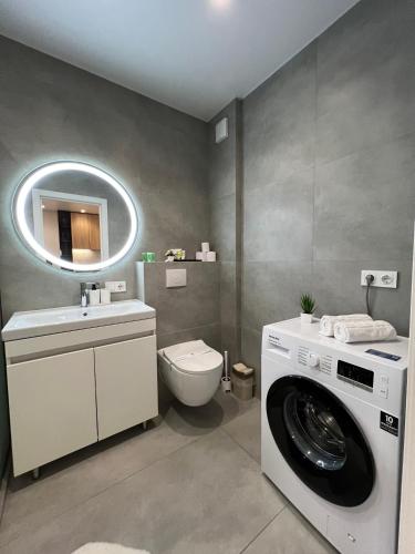 a bathroom with a washing machine and a sink at Cruds Arena Chisinau in Chişinău