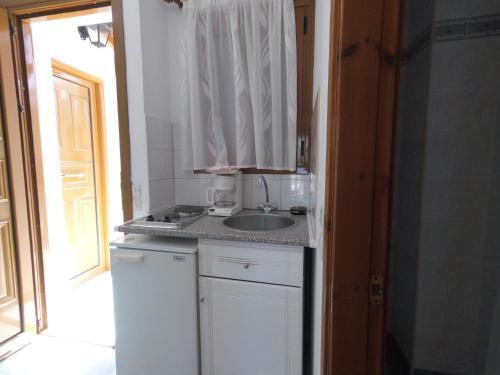 a kitchen with a sink and a counter top at Poseidon Studios in Kokkari