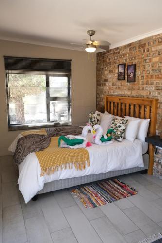 a bedroom with a bed with stuffed animals on it at Blue Sky Retreat in Vredenburg