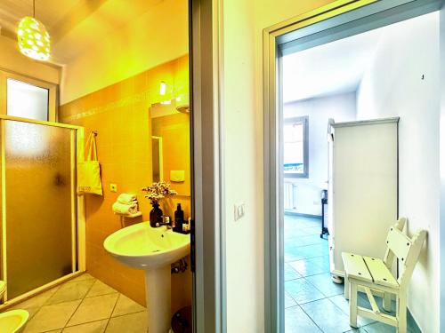 a bathroom with a sink and a toilet and a mirror at Casa Appia - Authentic Beachfront House with Sea- View Garden in Santa Maria al Bagno - Marea Stays Collection in Nardò