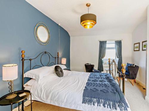 a bedroom with a bed with a cat laying on it at 3 Bed in Holmfirth oc-91797 in Holmfirth