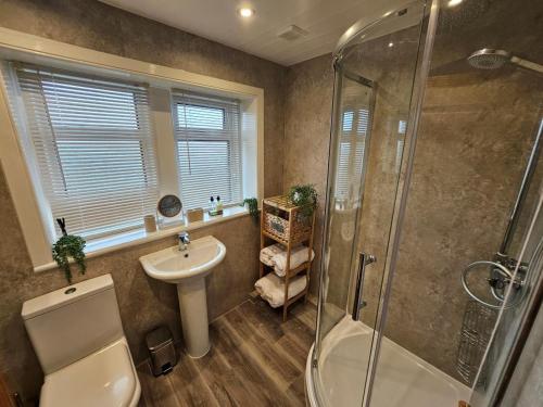 a bathroom with a toilet sink and a shower at 3 Bed in Holmfirth oc-91797 in Holmfirth