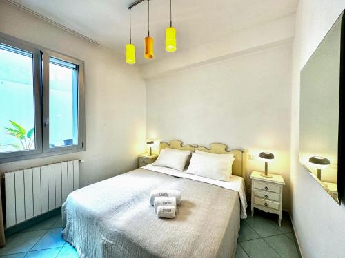 a bedroom with a large bed with two lamps and a window at Casa Appia - Authentic Beachfront House with Sea- View Garden in Santa Maria al Bagno - Marea Stays Collection in Nardò