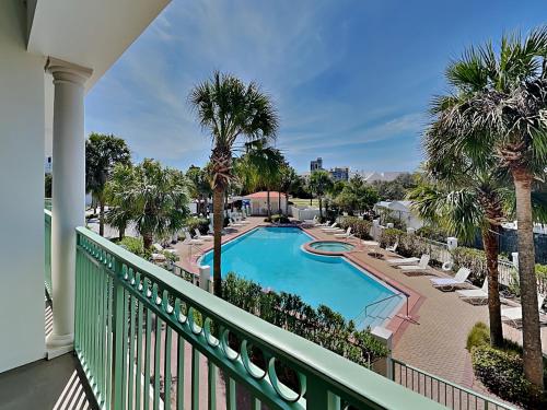 a balcony with a swimming pool and palm trees at Inn at Seacrest #203 - 30A Get-A-Way in Rosemary Beach