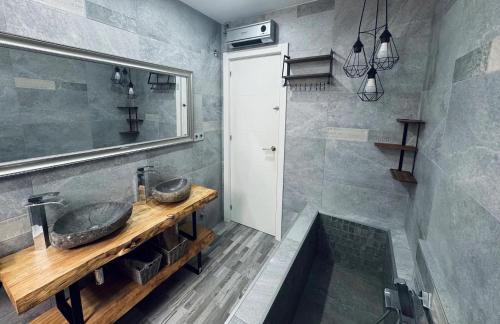 a bathroom with a sink and a shower at Villa puerto marina beach in Benalmádena