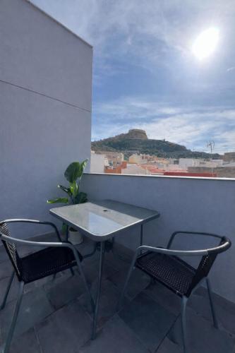 a table and two chairs on a balcony at Hotel Wayteko San Antón in Alicante