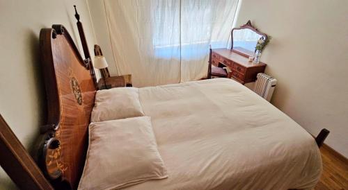 a bedroom with a bed and a dresser and a window at Rooms São Dinis in Porto