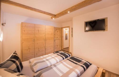 two beds sitting next to each other in a room at Haus Maria Larcher in Bach