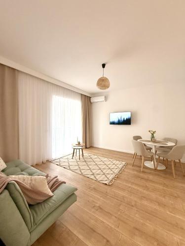 a living room with a couch and a table at Forestis Thermalis in Baile Felix