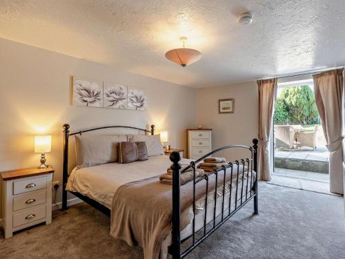 a bedroom with a bed and a large window at 2 Bed in Holsworthy oc-00813 in Pyworthy