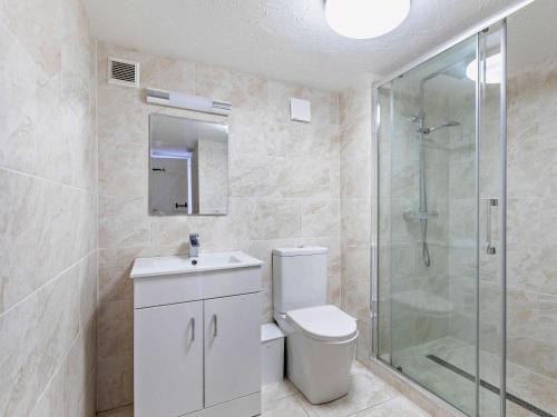 a bathroom with a toilet and a glass shower at 2 Bed in Holsworthy oc-00813 in Pyworthy