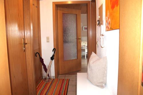 a hallway with an open door with an umbrella at FeWo Alte Post in Oberdigisheim