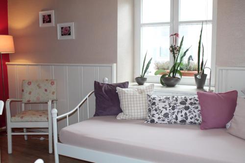 a room with a bed with pillows and a window at FeWo Alte Post in Oberdigisheim
