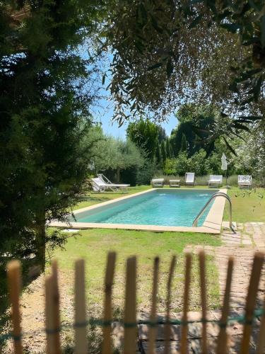 a swimming pool with a slide in a yard at Bosco Ai Marzi - 2 Apartments with shared pool in Poggibonsi