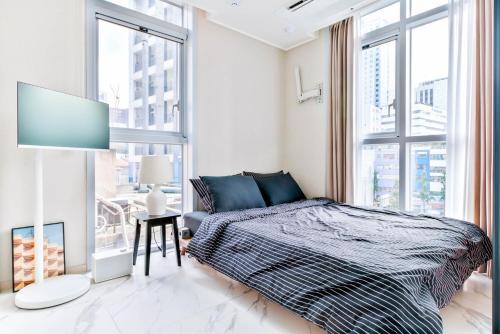 a bedroom with a bed and a large window at Balance Seoul Stay in Seoul
