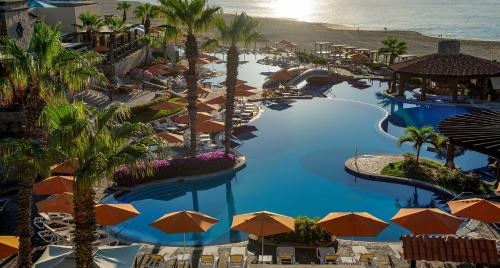 an aerial view of a resort swimming pool with umbrellas at Pueblo Bonito Sunset Beach Owners Studio Suite, REQUEST DATES see by Clay & Lisa in Cabo San Lucas