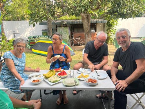 a group of people sitting around a table eating food at Villa 87 in Katunayaka