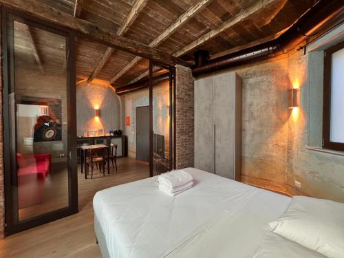 a bedroom with a bed and a dining room at Emmeloft I Orange Moon - Vibrant Modern Luxury Loft Milan in Milan