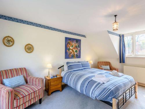 a bedroom with a bed and a chair at 5 Bed in Wareham oc-dc032 in West Lulworth