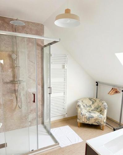 a bathroom with a shower with a glass shower stall at La perle du Centre à Cancale in Cancale