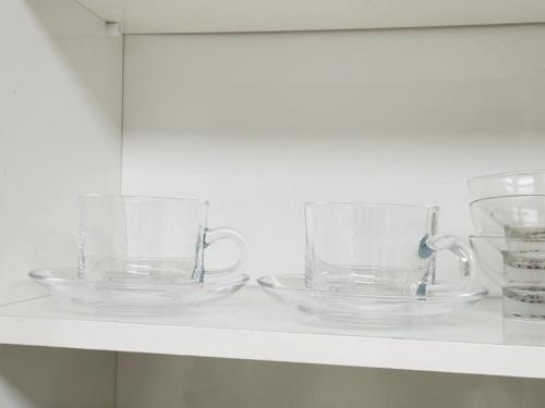 two clear glass bowls sitting on a shelf at Gaegum Moonlight Stay in Busan
